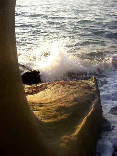 Sunset on a rocky beach-pointy-wave-rock.jpg