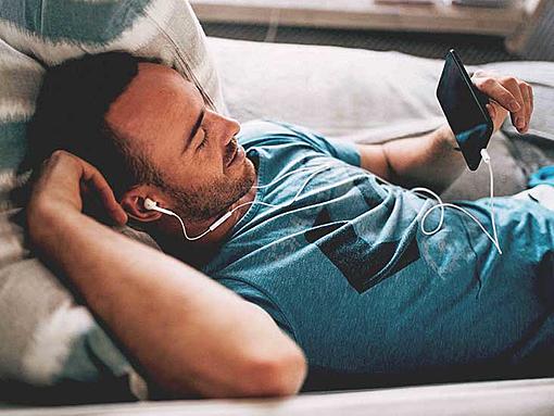 What makes men low on energy?-4508-male_laying_couch_earbuds_looking_phone-732x549-thumbnail.jpg